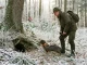 Hundeführer mit Erdhund bei der Baujagd auf Fuchs an einem winterlichen Fuchsbau.