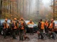 Jagdleitung erläutert den Ablauf einer Gesellschaftsjagd vor dem Einsatz im herbstlichen Wald.